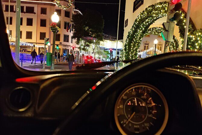 Funchal Christmas lights sightseeing night tour - Passing the Farmers Market: local texture between the big displays